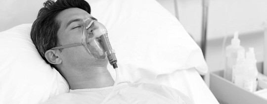 Unconscious male patient on respiratory support